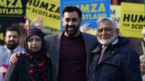 PA Media Humza and parents