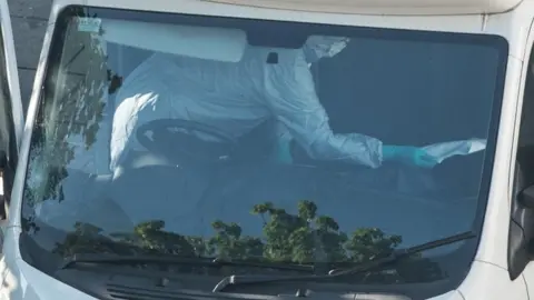 Getty Images Forensic teams examine the hire van