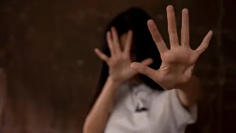 Getty Images Creative image of a young woman putting her hand out