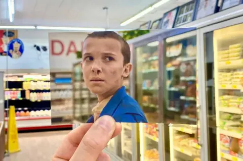 Thomas Duke/Stepping Through Film Photo of Eleven in Stranger Things in the supermarket where the scene was shot