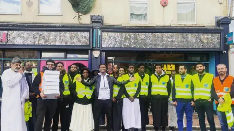 Bristol City Council Grand Iftar celebrations on St Mark's Road in 2019 with several men lined up facing the camera