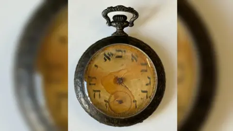 Henry Aldridge & Son Ltd A rusted open-face pocket watch with faded Hebrew numerals and corroded hands