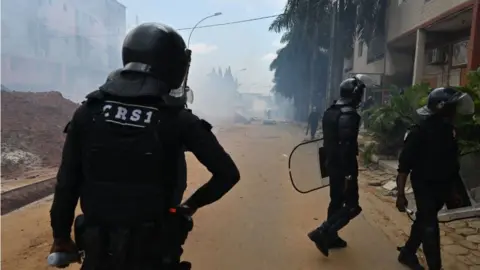 AFP Ivorian anti-riot police use tear gas to disperse opposition supporters in Blockhauss, Abidjan.