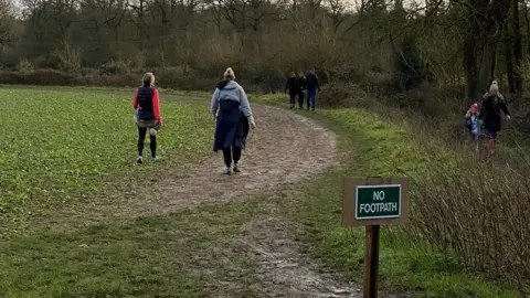 Simon Beddows People walking off the footpath on crops