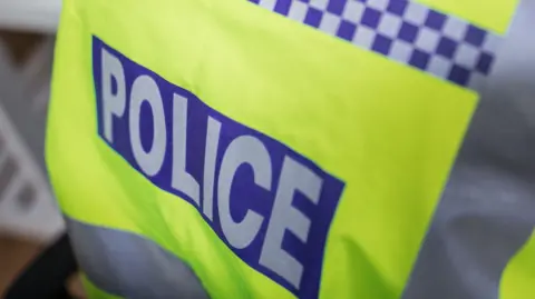 A police high-visibility jacket. 