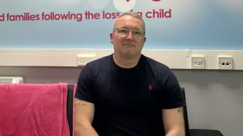 Rob Lapsley, a middle-aged man with glasses.