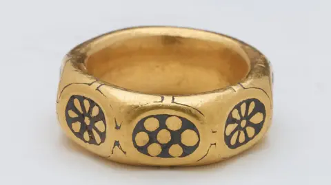 British Museum Undated handout photo issued by the British Museum of a gold ring with a black-coloured pattern on it from the ninth century that was part of a £3 million Viking hoard.