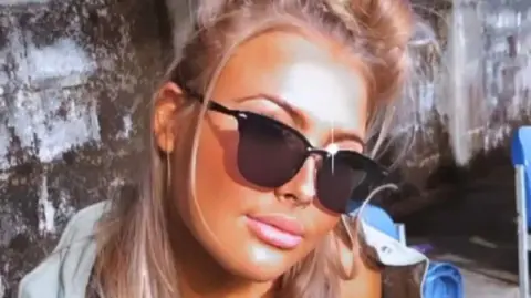 Danielle O'Halloran Picture of Chloe looking at the camera wearing sunglasses. There is a effect on the picture which is making it brighter and smoother. 