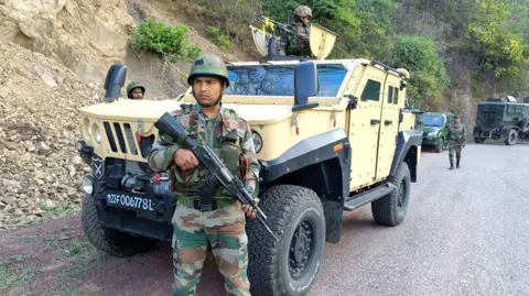 Getty Images Indian army personnel look on during a search operation in Reasi on June 10, 2024, after gunmen in Kashmir ambushed the bus packed with Hindu pilgrims. Soldiers in India-administered Kashmir carried out a large-scale manhunt on June 10, the government said, a day after nine Hindu pilgrims were killed in one of the deadliest recent attacks on civilians, around an hour before Hindu-nationalist Prime Minister Narendra Modi was sworn in for a third term in the capital New Delhi on June 9 evening. (Photo by AFP) (Photo by -/AFP via Getty Images)