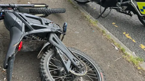 An electric bike on its side on the ground