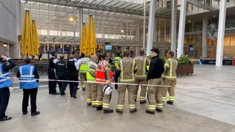 JAMES J. MARLOW via Reuters Emergency services at the base of The Shard