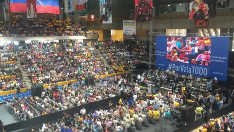 People gather in a hall for a political rally