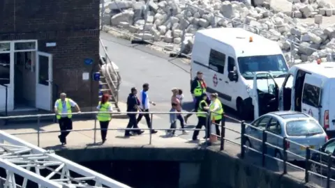 Gareth Fuller, PA Migrants arriving at Dover