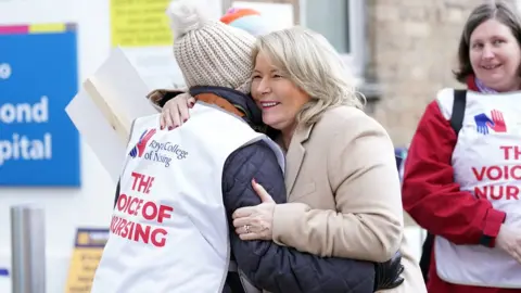 PA Media Pat Cullen, general secretary of the Royal College of Nursing, hugging a union member outside Great Ormond Street Hospital