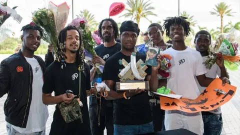 Getty Images The family of XXXTentacion collects items from a makeshift memorial outisde his funeral