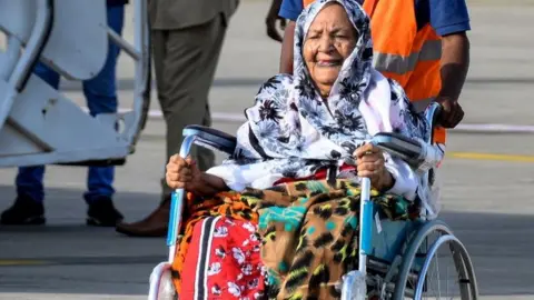 Getty Images An elderly passenger is wheelchaired after disembarking off an EgyptAir aircraft upon landing for the first time at Port Sudan International Airport on September 5, 2023 upon the inauguration of a new international flight route between Cairo and Port Sudan