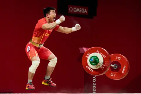 Isaac Julián Morillas Sánchez L.J. Chen, celebrates his Gold win in Men’s 67kg Weightlifting, Olympics 2020, Tokyo, Japan.