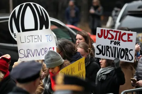 Getty Images Protesters held signs outside the court on Monday