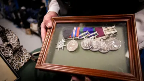 Framed medal collection left on a train, now with the Transport for Wales lost property office in Newport