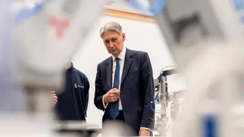 Gety Chancellor Philip Hammond at an engineering training facility