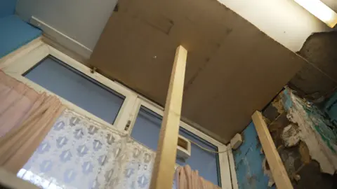 BBC News Wooden beams hold up the kitchen ceiling