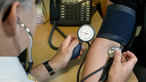 PA Media A stock image of blood pressure being taken