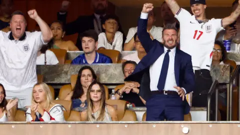 Getty Images Victoria Beckham appeared stone-faced as her family react with cheers to England's victory against Norway at last week's match