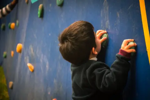 Macarena Norambuena  A child uses one of the climbing walls installed by Deporte Libre