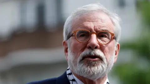 REUTERS/Clodagh Kilcoyne A man with a white beard and brown rimmed glasses looks off camera. All that is visible is his face - it is an up close picture.  