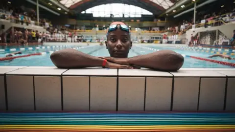 AFP Ugandan swimmer Clare Byarugaba poses during the swimming competition at the 2018 Gay Games