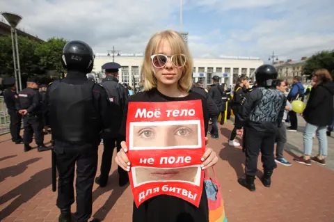 Getty Images Demonstrator in St Petersburg - the sign says, "My body is not a battlefield"