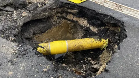 Dave Higgens / PA Media Water from a burst pipe leaked into the gas main