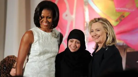 AFP US First Lady Michelle Obama (L) and Secretary of State Hillary Clinton pose with Samar Badawi of Saudi Arabia as she receives the 2012 International Women of Courage Award during a ceremony at the US State Department in Washington DC