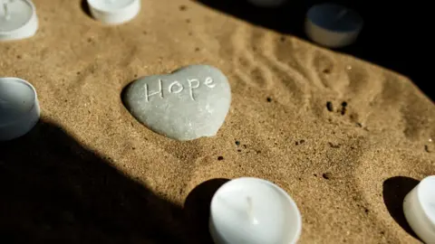 BBC An inscribed pebble in St Helena Hospice chapel