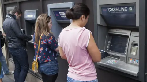 Getty Images people at cash machine in Edinburgh