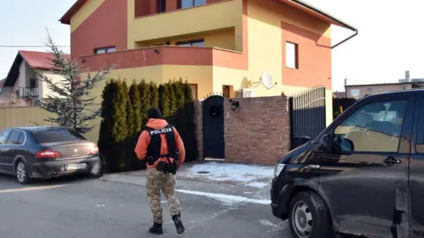 AFP A Slovak policeman walks outside a house linked to Italian businessman Antonin Vadala during a police search