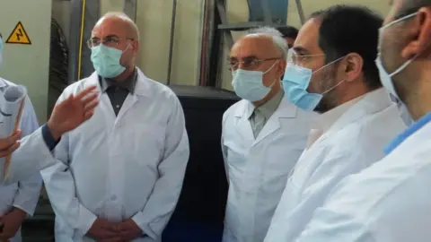 EPA A handout photo made available by the Atomic Energy Organisation of Iran shows Iranian Parliamentary speaker Mohammad Baqer Qalibaf (L) and head of Atomic Energy Organisation of Iran Ali Akbar Salehi (2nd L) visiting the Fordo enrichment facility in Iran (28 January 2021)