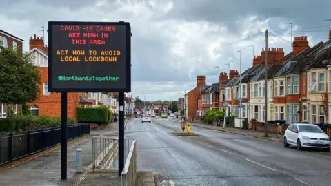 BBC Sign warning people about Covid-19 in Northampton