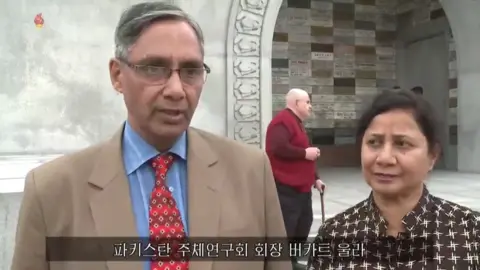 Korea Central Television The chair of Pakistan's Juche study group and his wife are shown visiting Pyongyang for the Day of the Sun.