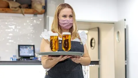 Getty Images Waitress wearing face mask