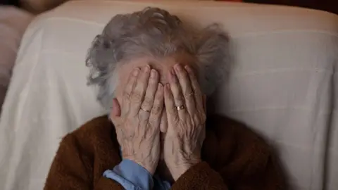 Getty Images Woman covering her face