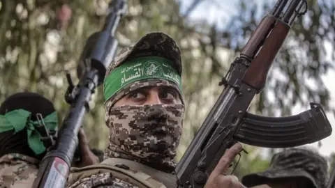 EPA Fighters in Hamas's military wing march in Gaza City on Saturday