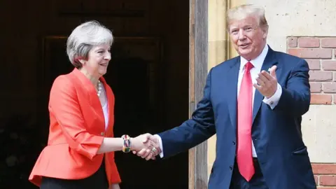 Getty Images Donald Trump and Theresa May shaking hands outside Chequers
