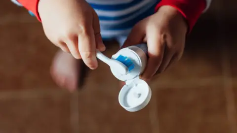 Getty Images Stock image of a child with a toothbrush