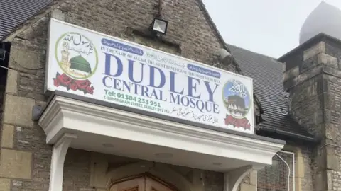 An old Victorian-style school building with the sign Dudley Central Mosque on top of the front door