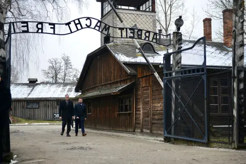 Bartosz Siedlik / AFP Second Gentleman of the United States Douglas Emhoff walks through the camp's main gate at the Memorial and Museum Auschwitz-Birkenau in Oswiecim, Poland on 27 January 2023