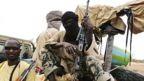 Reuters Militiaman from the Ansar Dine Islamic group sit on a vehicle in Gao in north-eastern Mali in 2012