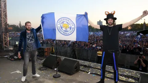 Getty Images/Plumb Images Band members hold LCFC flag