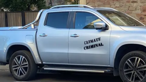 Brian Latham Car with 'climate criminal' written on the side