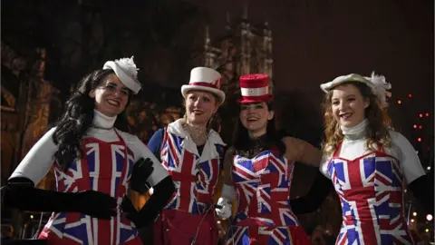 DANIEL LEAL-OLIVAS/AFP via Getty Images Pro-Brexit supporters don Union Jack-themed clothes pose for a photograph in Parliament Square, the venue for the Leave Means Leave Brexit Celebration.